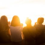 Friends outside watching sunset