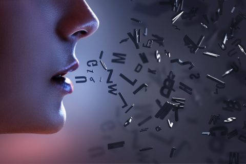 A photo illustration of letters coming out of a woman's mouth.
