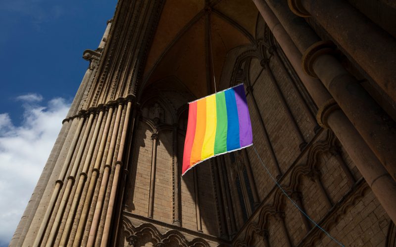 A view of a Pride flag hanging from Peterborough Cathedral