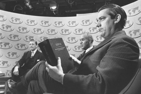 Sen. Fred R. Harris (D-Okla.), holds a copy of the report of the National Advisory Commission on Civil Disorders as he and two other members of the commission discuss the study on the television-radio program "Issues and Answers," in Washington, March 3, 1968. With him are the commission's chairman, Gov. Otto Kerner of Illinois, right, and Roy Wilkins, center, executive director of the NAACP.