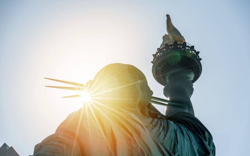 Photo of the Statue of Liberty in the sunset.