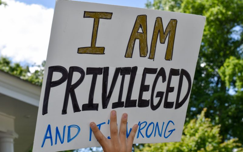 A High School Student Holding Up A Sign That Says "I Am Privileged And It's Wrong."