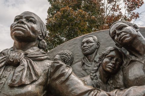 A statue of Harriet Tubman and some of the people she helped.