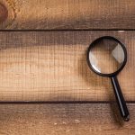 magnifying glass on the wooden background