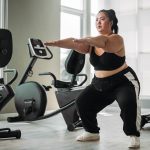 Woman in workout clothes doing squats