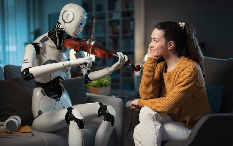 A young woman listens as a robot plays a violin