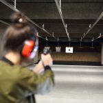 A woman at a gun range