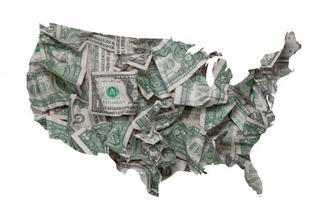 An outline of the United States filled with dollar bills