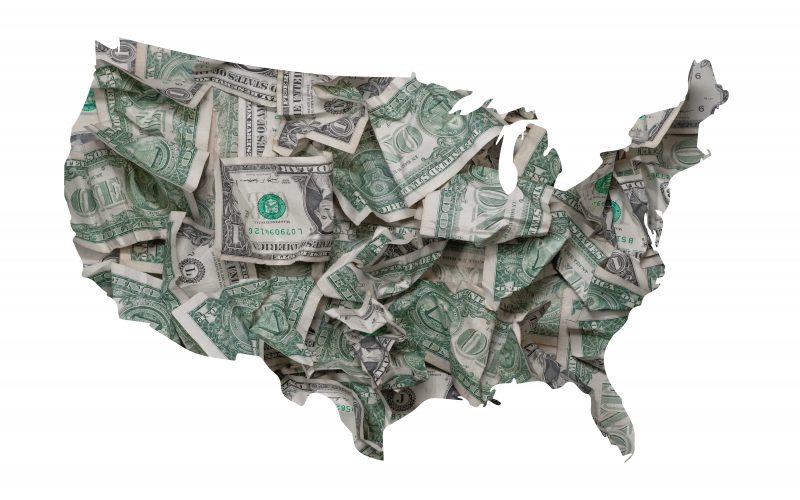 An outline of the United States filled with dollar bills