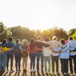 A group of people hugging one another