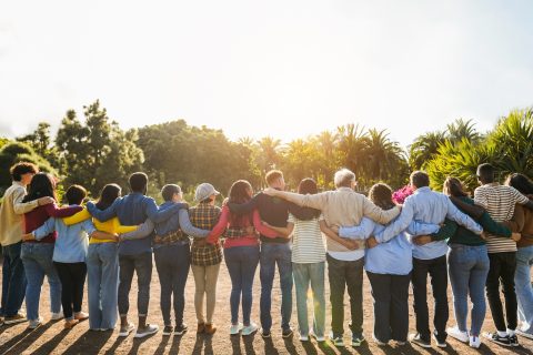 A group of people hugging one another