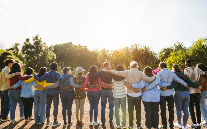 A group of people hugging one another